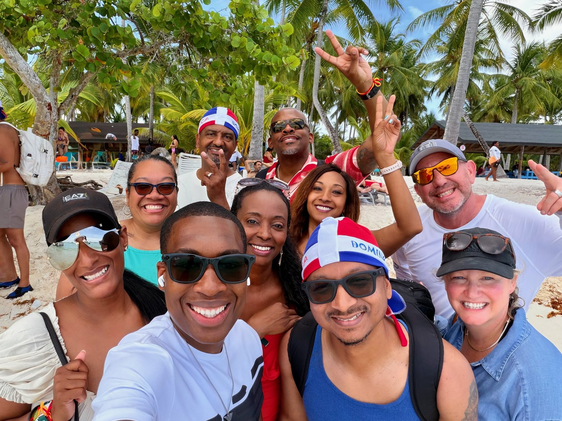 Friends on a beach under palm trees