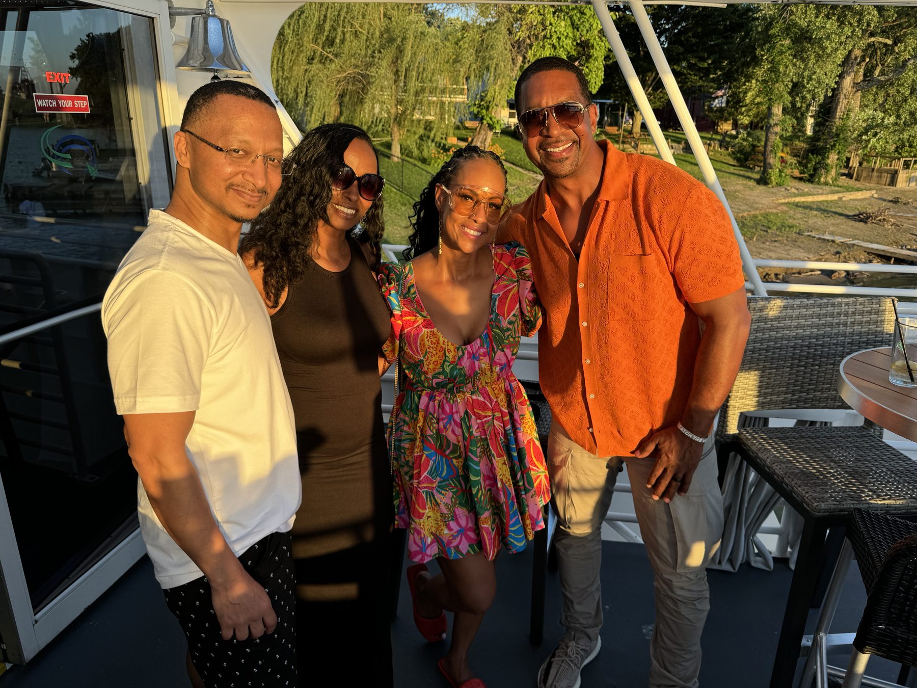Herman and Rontunya with friends on a boat at sunset