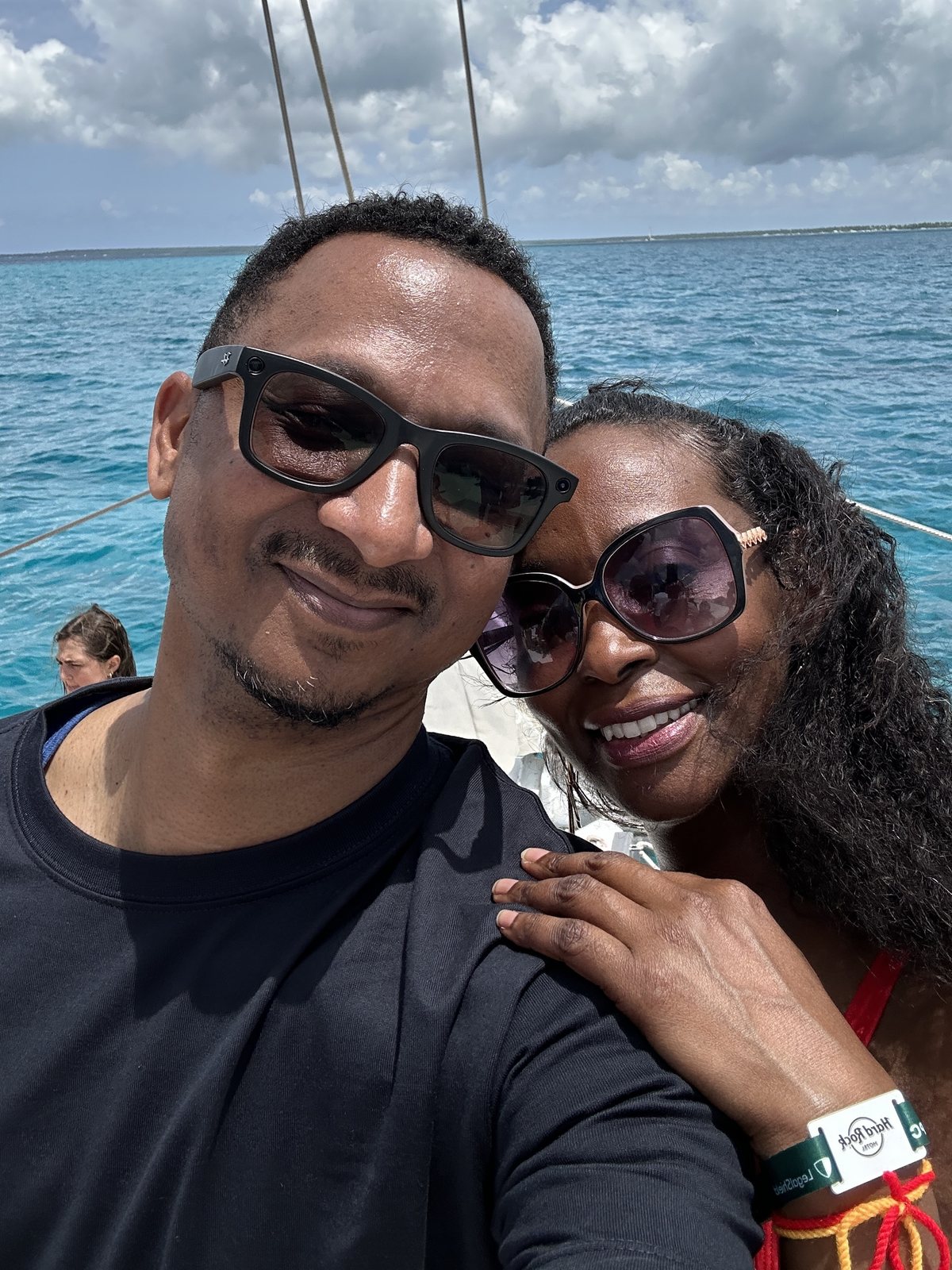 Herman and Rontunya on a boat with turquoise water behind them