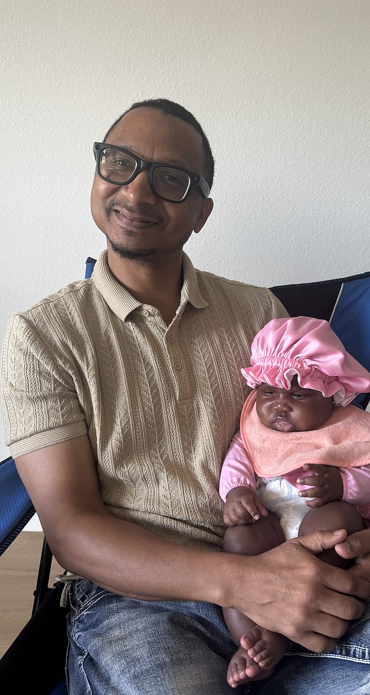 Herman holding a baby
