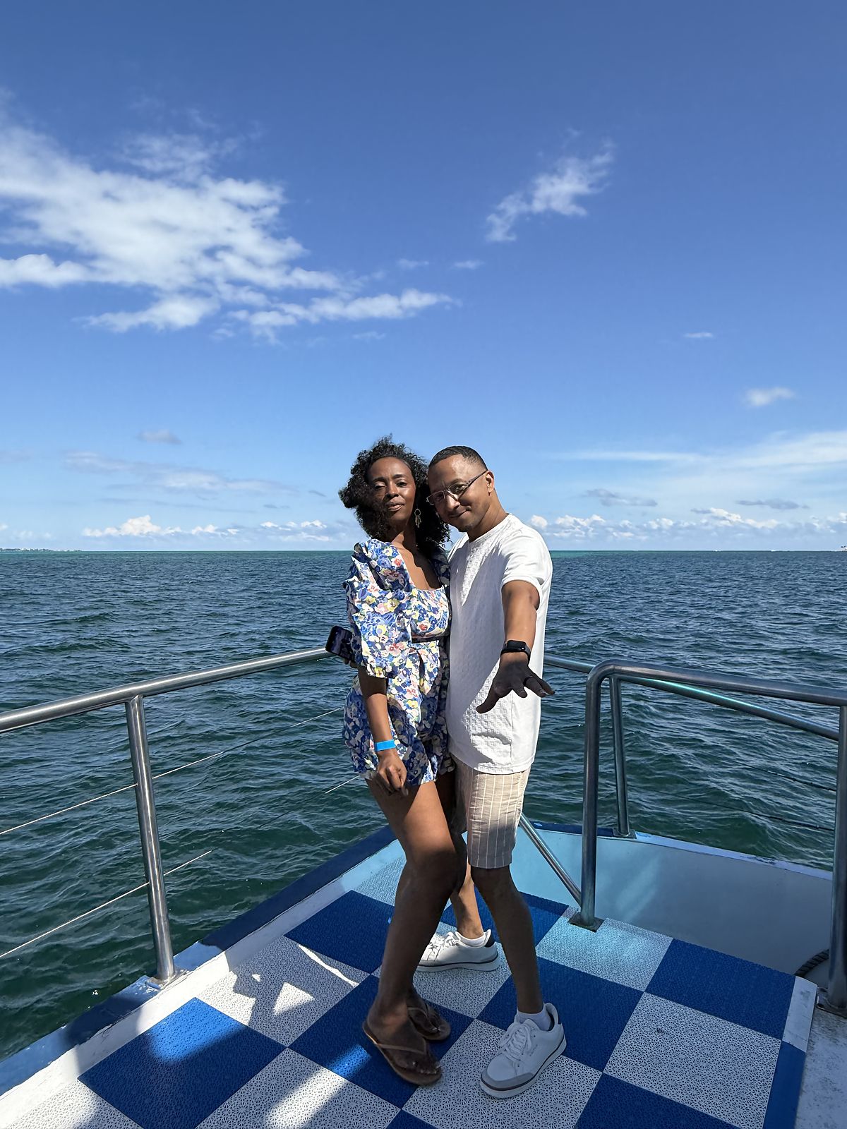 Couple on the bow of a boat on open water