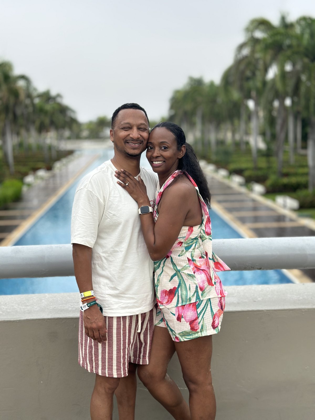 Herman and Rontunya in front of a palm-lined walk
