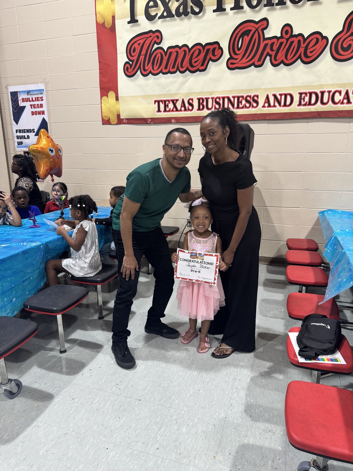 Herman and Rontunya at a Pre-K celebration with their granddaughter