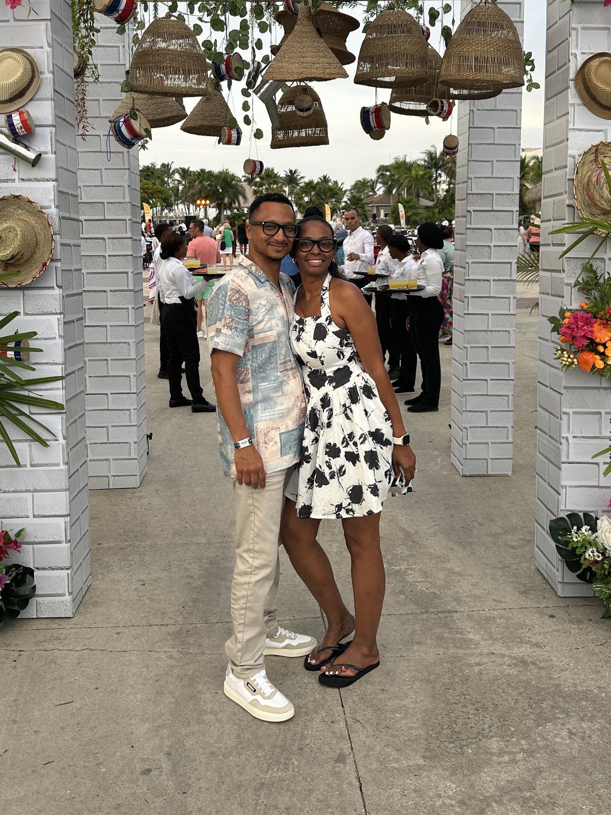 Herman and Rontunya under a floral arch at a resort