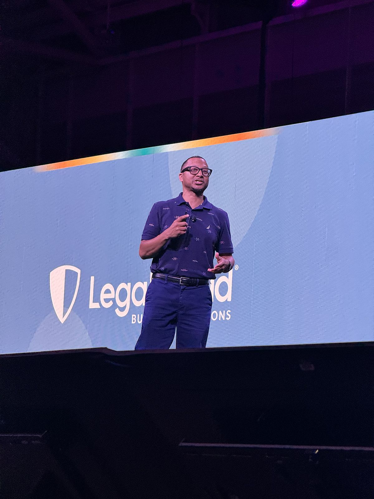 Herman speaking on stage