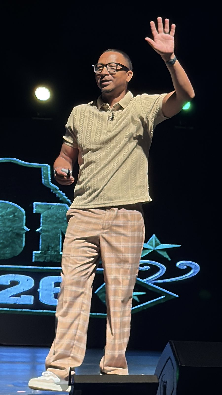 Herman on stage waving to the audience